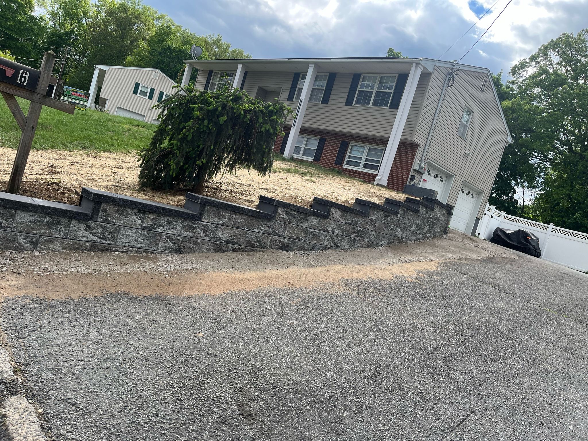 Stone retaining wall along driveway freshly installed