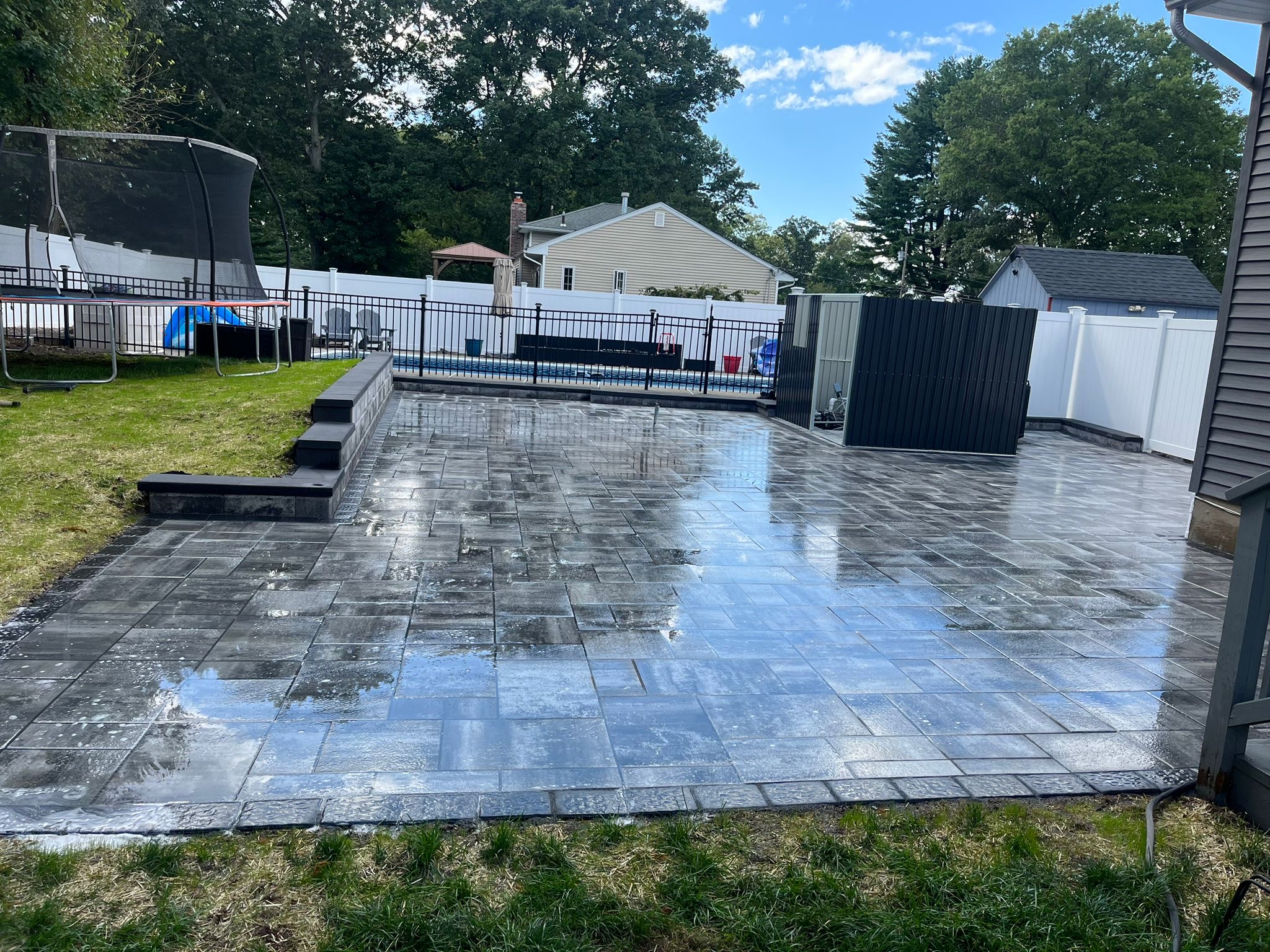 Large paver patio near pool